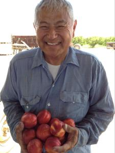 Nikiko’s father, David Mas Matsumoto, holding fresh nectarines.