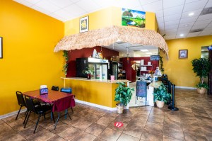 Wooden replicas of nacatameles hang from the ordering counter at Eda’s Latin Food in Manassas, Virginia.